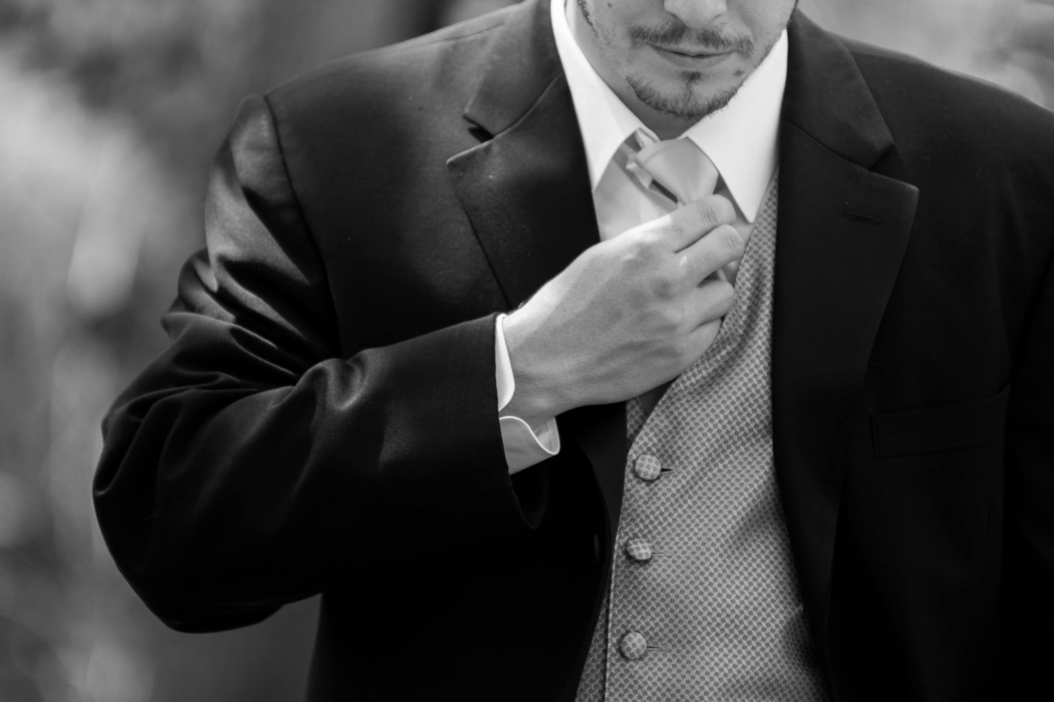 John-Paul in a suit, adjusting tie