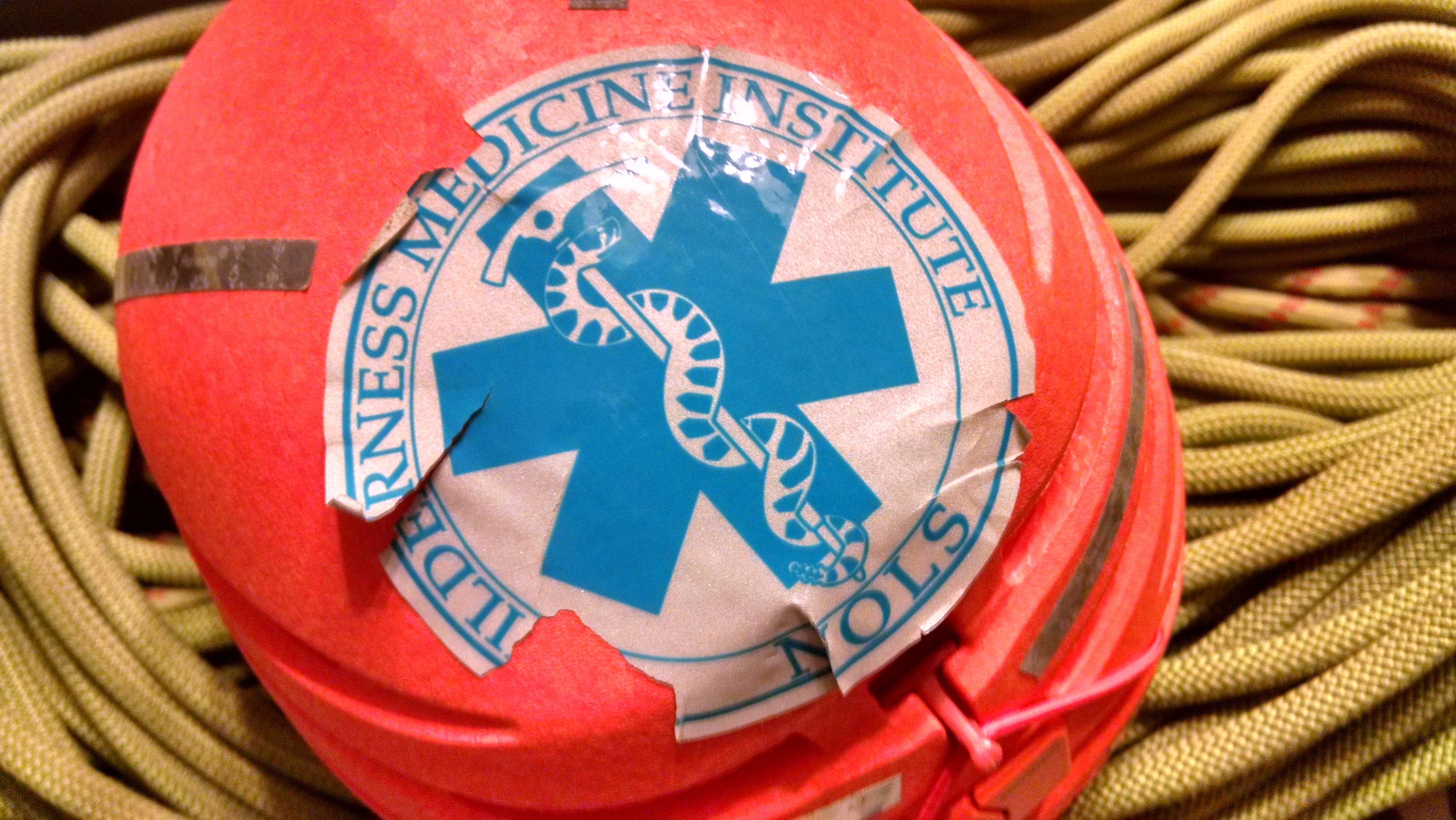 Wilderness First Responder sticker on helmet on top of climbing rope